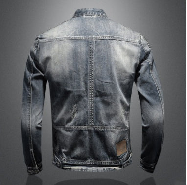 Denim jacket with a worn-out look on a dark background