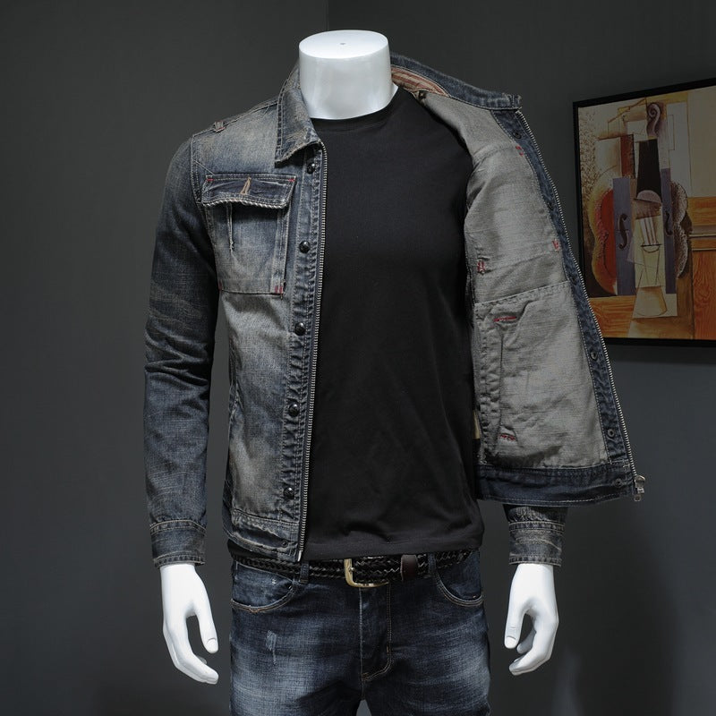 Mannequin wearing a denim jacket and black shirt against a dark background