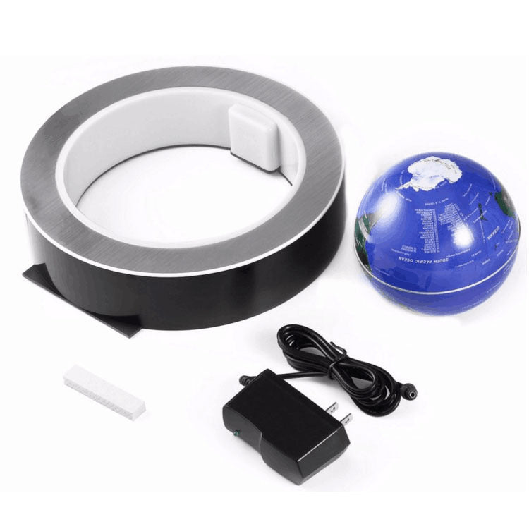 Roll of tape, blue ball with white design, power adapter on a white background