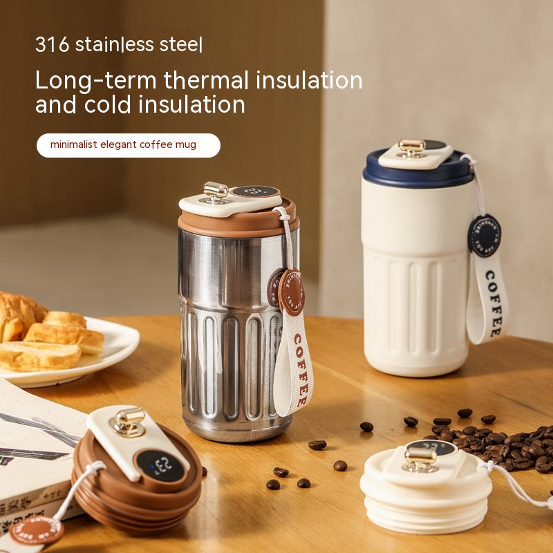 Two coffee mugs with different designs on a wooden table with coffee beans and pastries.