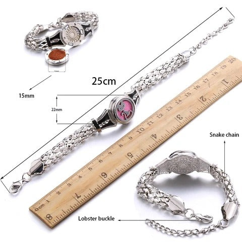 Silver bracelet with pink gemstone next to a ruler for measurement on a white background