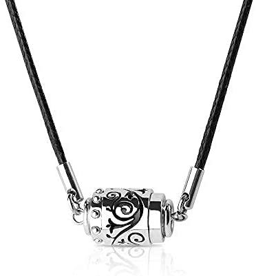 Silver cylindrical pendant with black design on a black cord against a white background