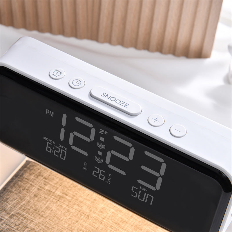 Digital clock with alarm and temperature display on a bed