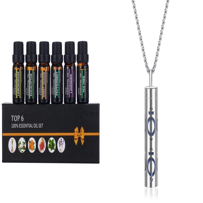 Set of essential oil bottles and a pendant on a white background