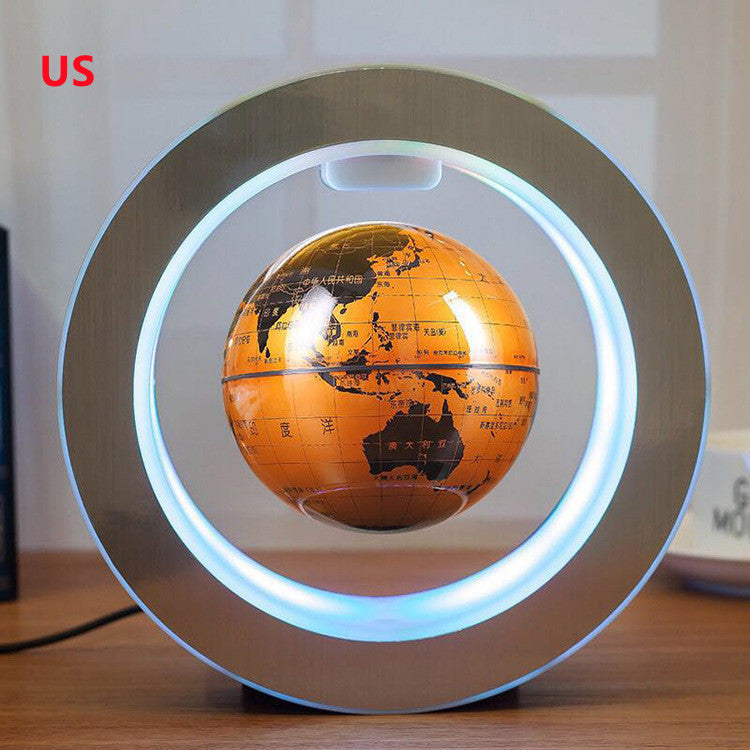 Levitating orange globe with LED light on a wooden surface