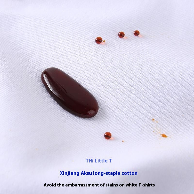 Chocolate sauce stain on white fabric with 'THI Little T' branding