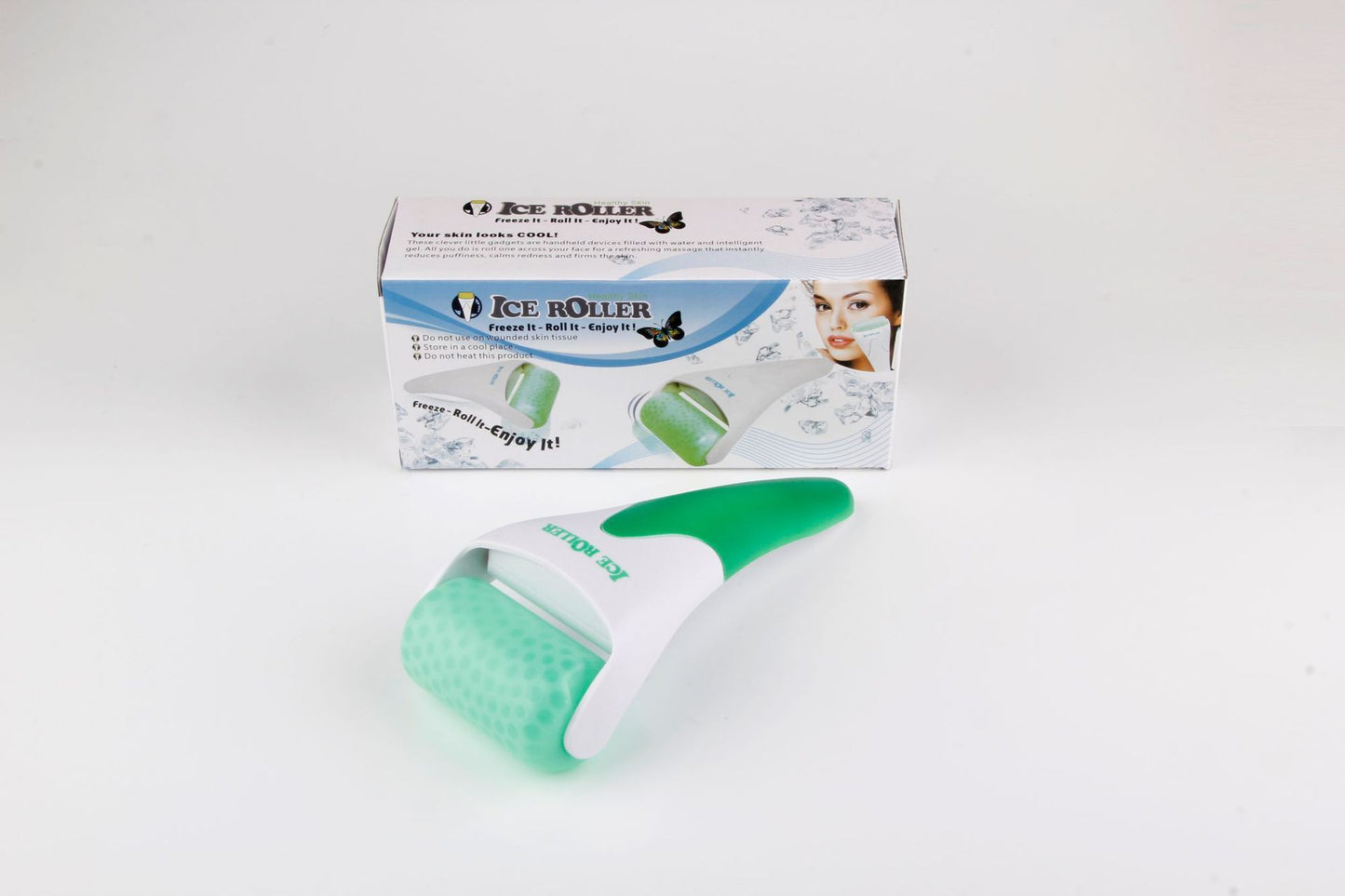 Green ice roller with packaging on a white background