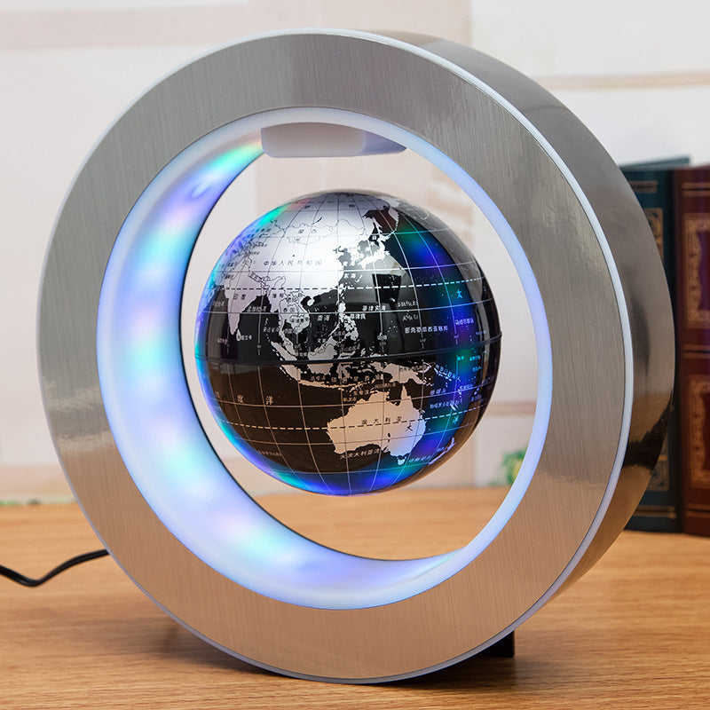Levitating globe with colorful lighting on a wooden surface