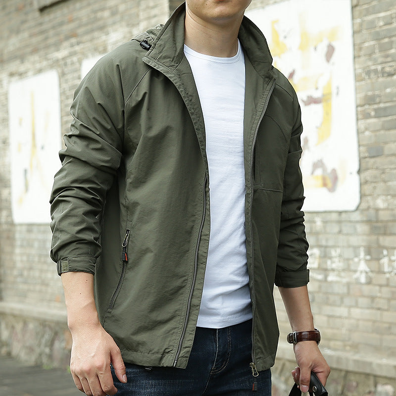 Person wearing a green jacket over a white shirt with a blurred background