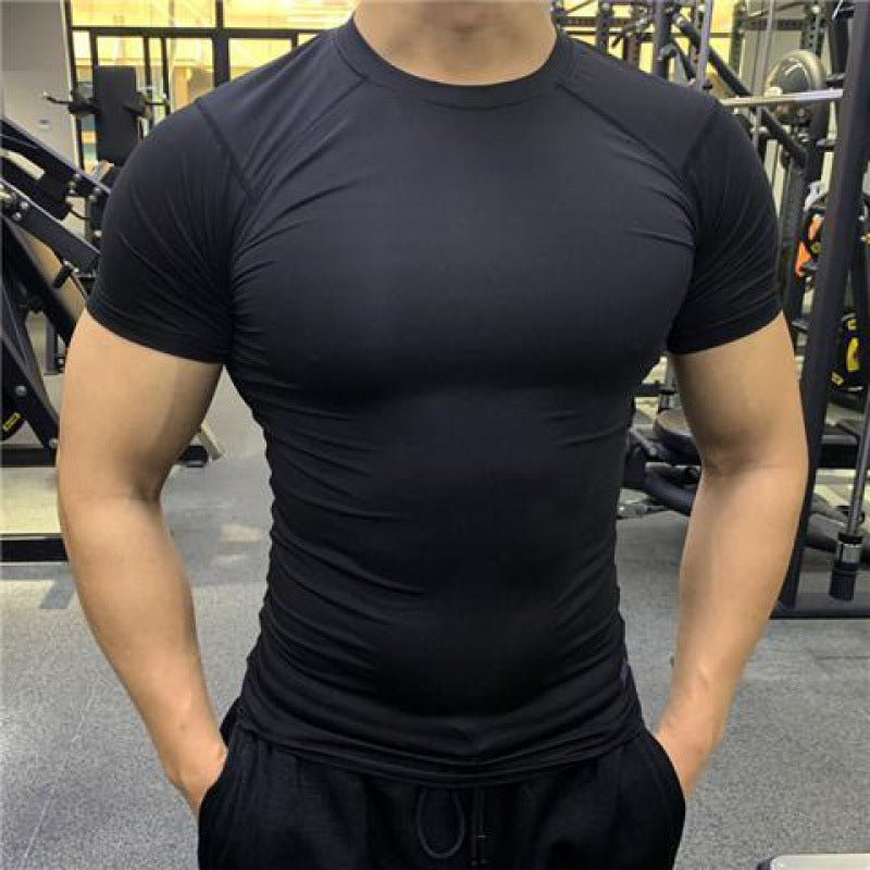 Person wearing a black athletic shirt in a gym setting