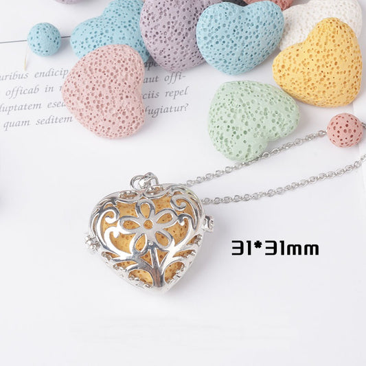 Heart-shaped pendant with decorative design on a white background with colorful stones.
