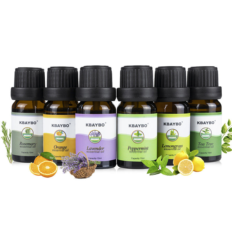 Set of KBAYBO essential oil bottles with corresponding labels and botanical elements on a white background