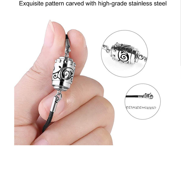 Silver charm with intricate design held by a hand, with close-up insets on a white background.