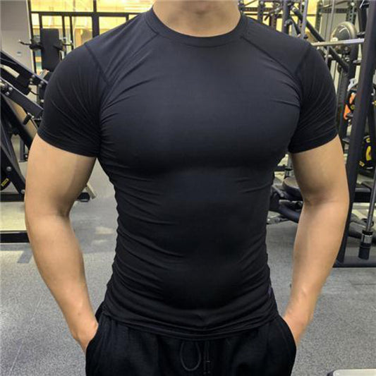 Person wearing a black athletic shirt in a gym setting