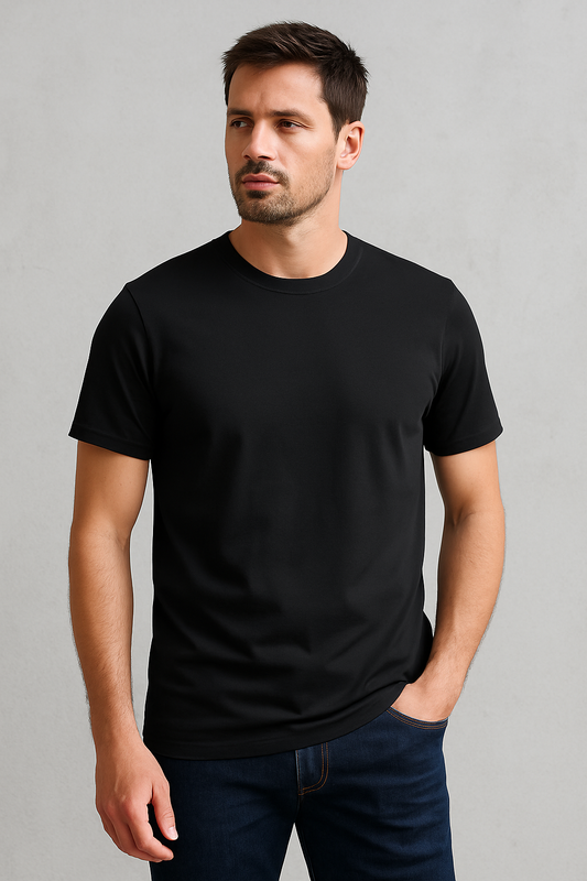 Man wearing a black t-shirt against a gray background